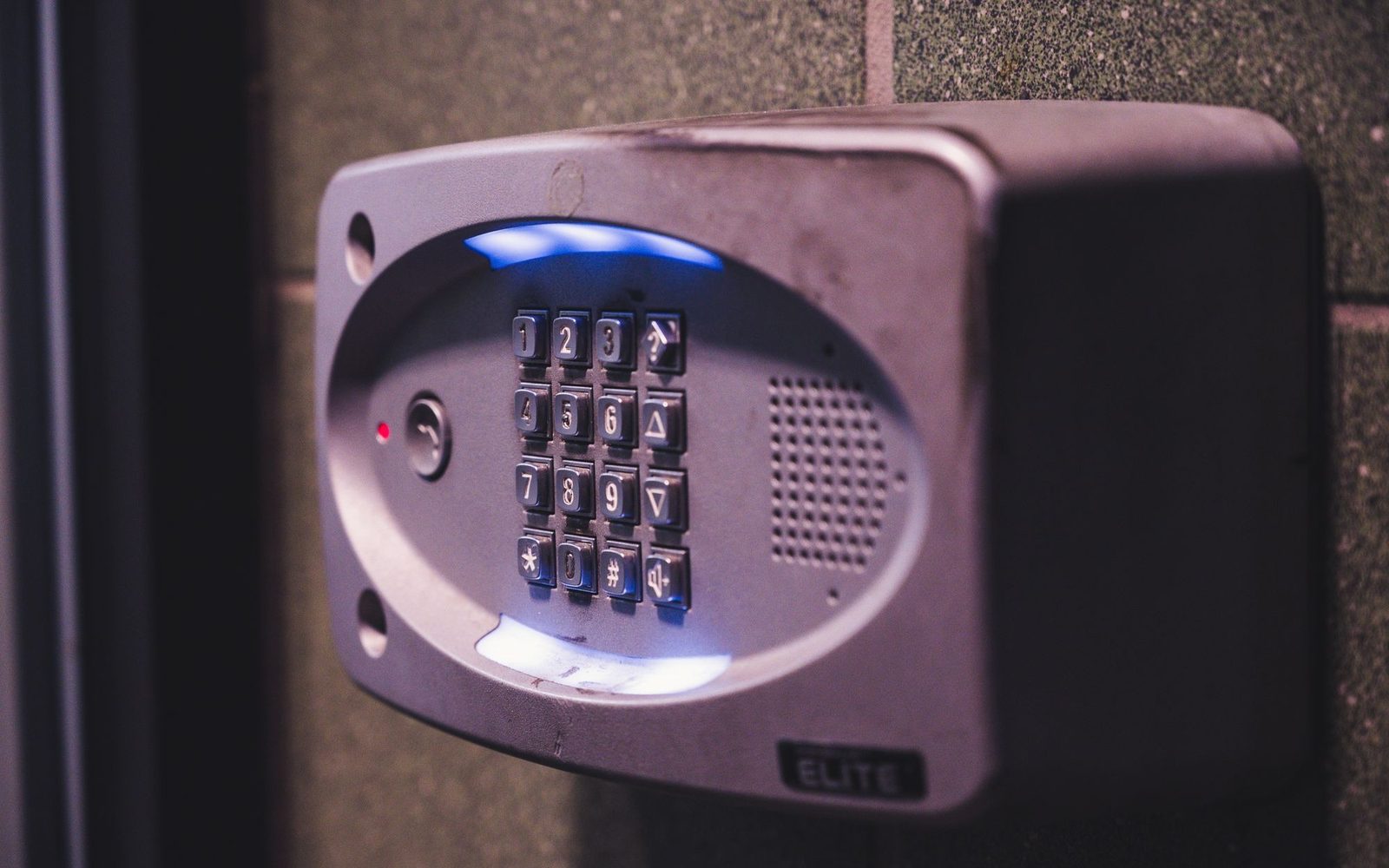 Illuminated alarm keypad mounted beside a door