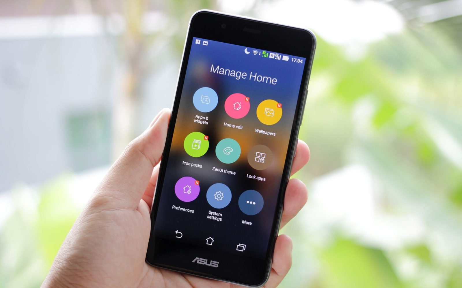 Hand holding a phone showing a home control app
